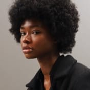 headshot photo of a Black woman with black curly hair