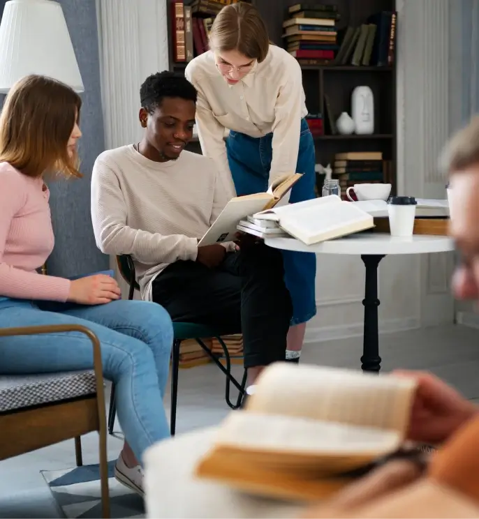 three people looking at a book